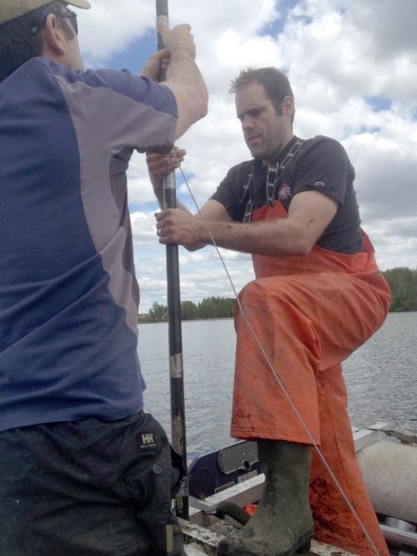 Collecting sediment cores in Guatemala.